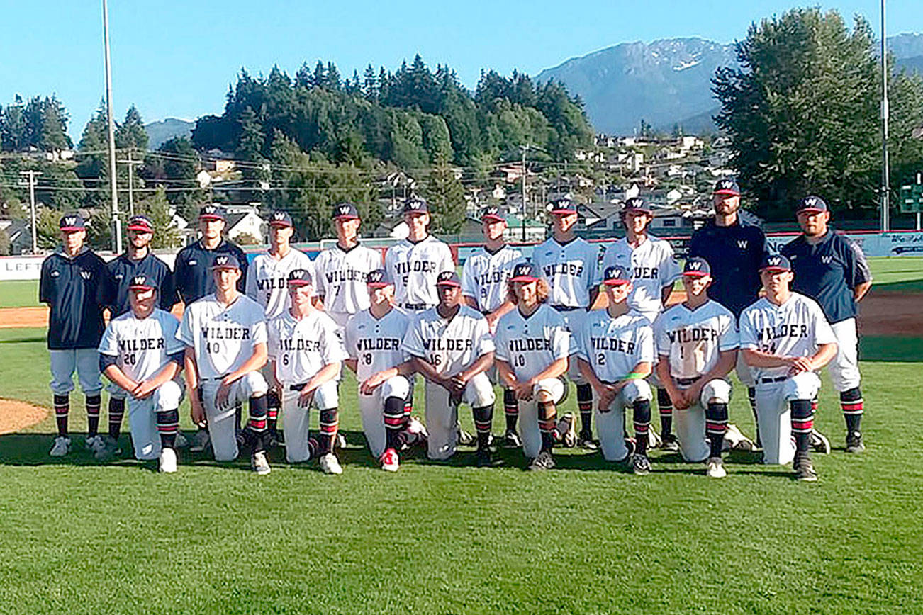 The Wilder Senior baseball club receives its championship trophy Sunday night at Civic Field after beating the Riverdogs 10-0 in the title game. Wilder went 6-0 in the Dick Brown Memorial Firecracker Classic. (Pierre LaBossiere/Peninsula Daily News)