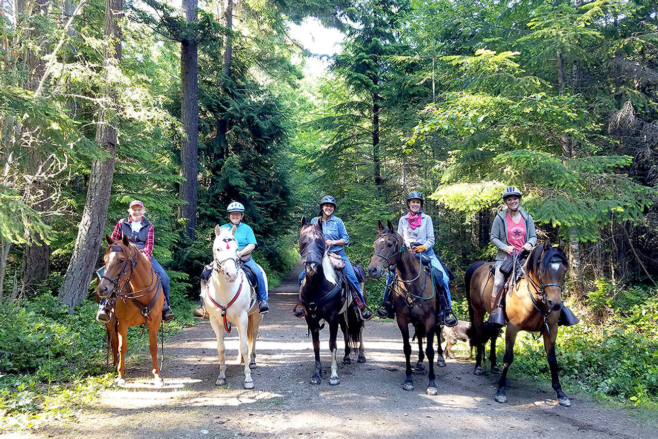 Backcountry Horseman Peninsula Chapter members Judy Dupree, left, and Linda Morin host guest riders from the Olympic Riders and Scattercreek chapters of BCH on a 12-mile ride through Miller Peninsula State Park (Photo courtesy of Linda Morin)