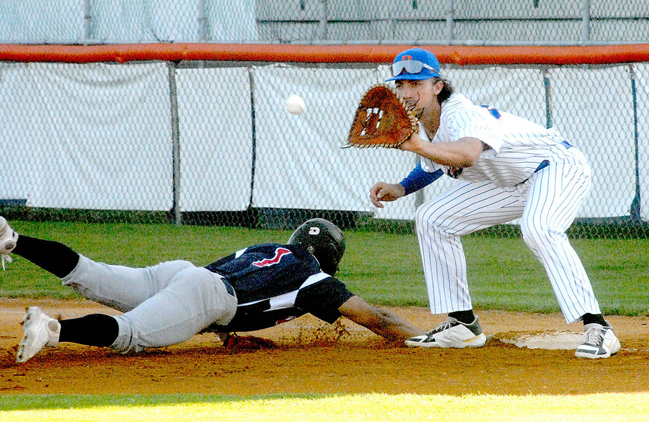 Keith Thorpe/Peninsula Daily News Lefties first baseman Jack Holman keeps Wenatchee’s Enzo Apodaca honest at the bag in the first inning on Thursday at Port Angeles Civic Field.