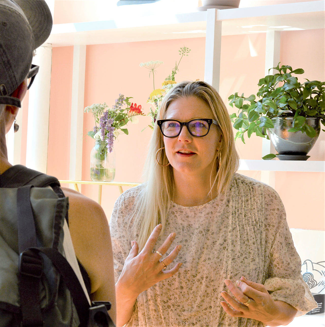 Vespertine Boutique’s Jaime Jaynes talks with one of her first customers. (Diane Urbani de la Paz/Peninsula Daily News)