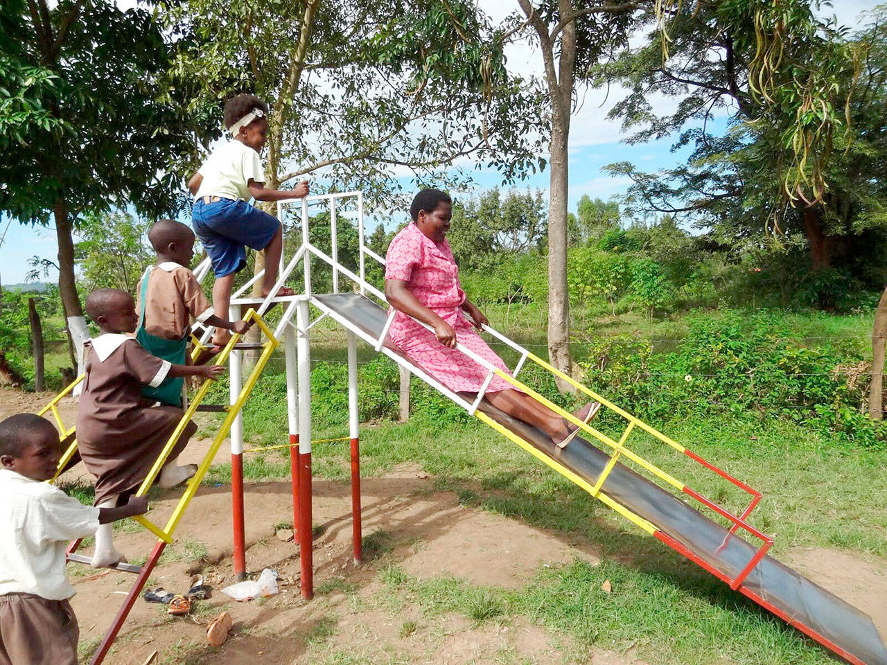 House mother and teacher Mama Ruth tries out the new slide at the Star of Hope Centre in Kenya. (photo courtesy of Star of Hope Centre)