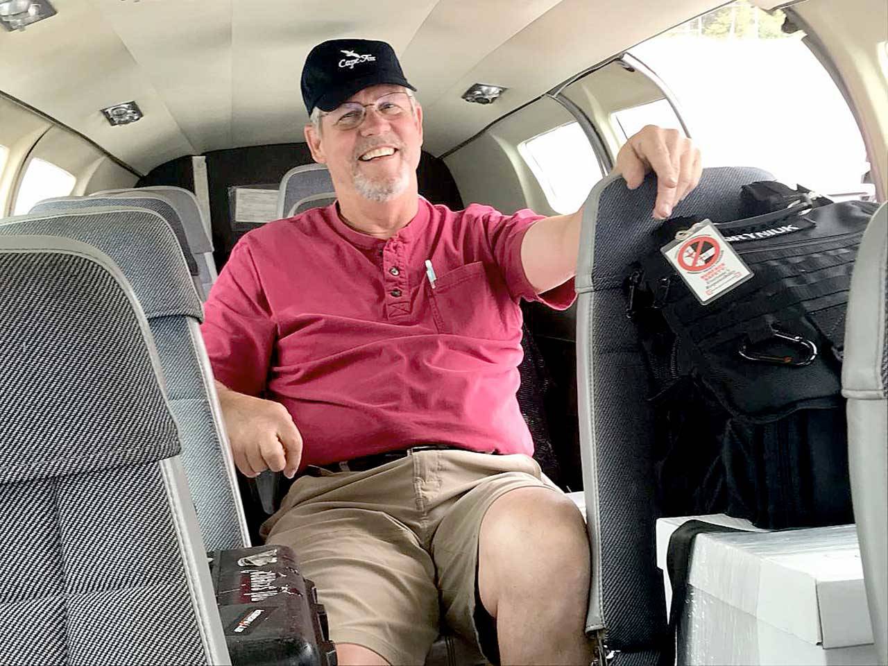 Retired pilot Josh Crabtree of Port Angeles sits in a Dash Air Shuttle Cessna 402c that he helped fly from the East Coast in June. The plane would be used for passenger flights from Fairchild International Airport in Port Angeles to Sea-Tac International Airport. (Paul Gottlieb/Peninsula Daily News)