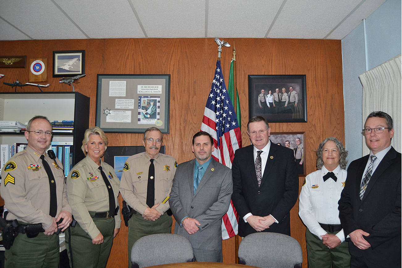 The Clallam County Sheriff’s Office's command staff with accreditation plaques from the Washington Association of Sheriffs and Police Chiefs. Pictured, from left, are Chief Civil Deputy Alice Hoffman, Sheriff Bill Benedict, Chief Criminal Deputy Brian King, Administrative Manager Lorraine Shore, Chief Corrections Deputy Wendy Peterson, Undersheriff Ron Cameron and Corrections Sergeant Don Wenzl.