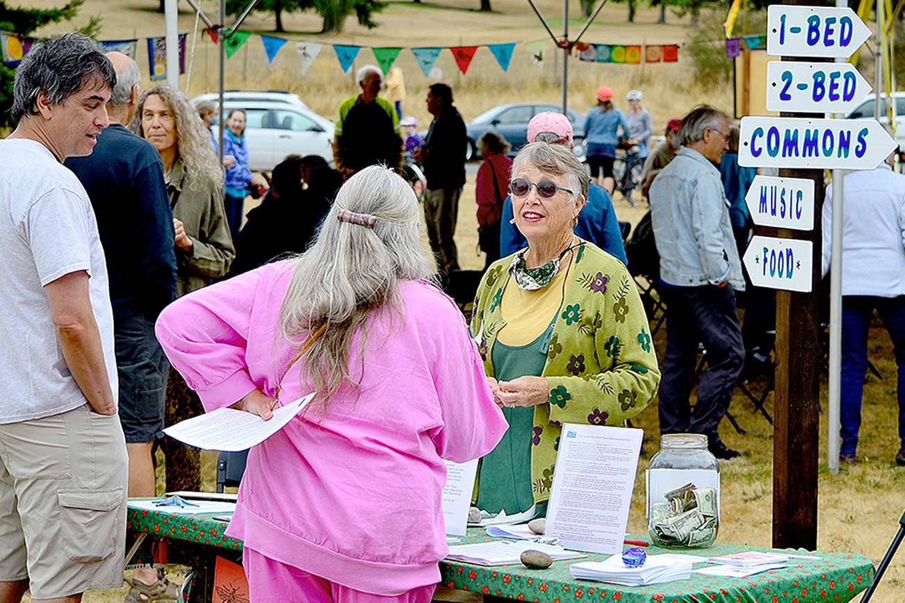 Volunteer coordinator Debbi Steele, center, welcomes visitors to Saturday’s Community Build Project open house in Port Townsend. (Diane Urbani de la Paz/Peninsula Daily News)