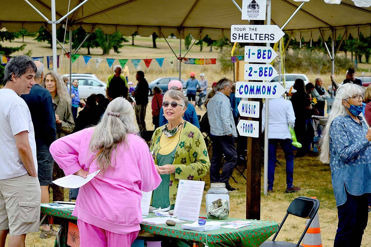 Volunteer coordinator Debbi Steele, center, welcomes visitors to Saturday’s Community Build Project open house in Port Townsend. (Diane Urbani de la Paz/Peninsula Daily News)