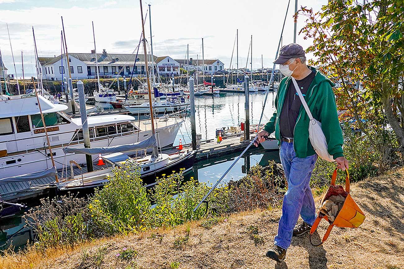 Gary Engbrecht has a hobby like no other. “Everyone needs a hobby,” he says. “Mine is picking up trash strewn around the town. I think I’ve emptied this bag about five times already and it is just 9 a.m.” During the weekend, Engbrecht, who is the production manager for the Port Townsend Film Festival, concentrated his efforts at the Point Hudson Marina in Port Townsend. (Steve Mullensky/for Peninsula Daily News)