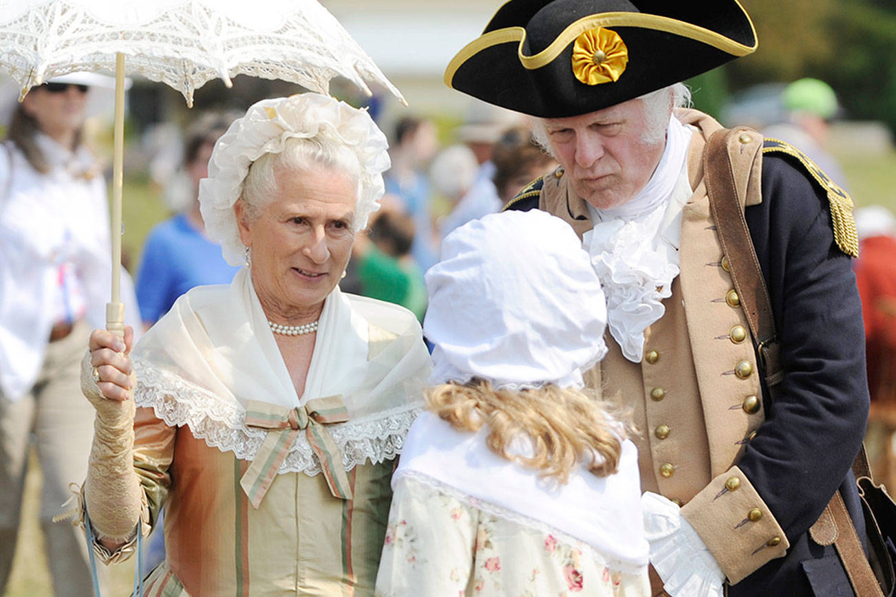 Martha Washington (Jane Ritchey) and George Washington (Vern Frykholm Jr.) meet with a young visitor at the Northwest Colonial Festival in 2019. The pair return this year today thorugh Sunday for daily visits with guests. Michael Dashiell/Olympic Peninsula News Group