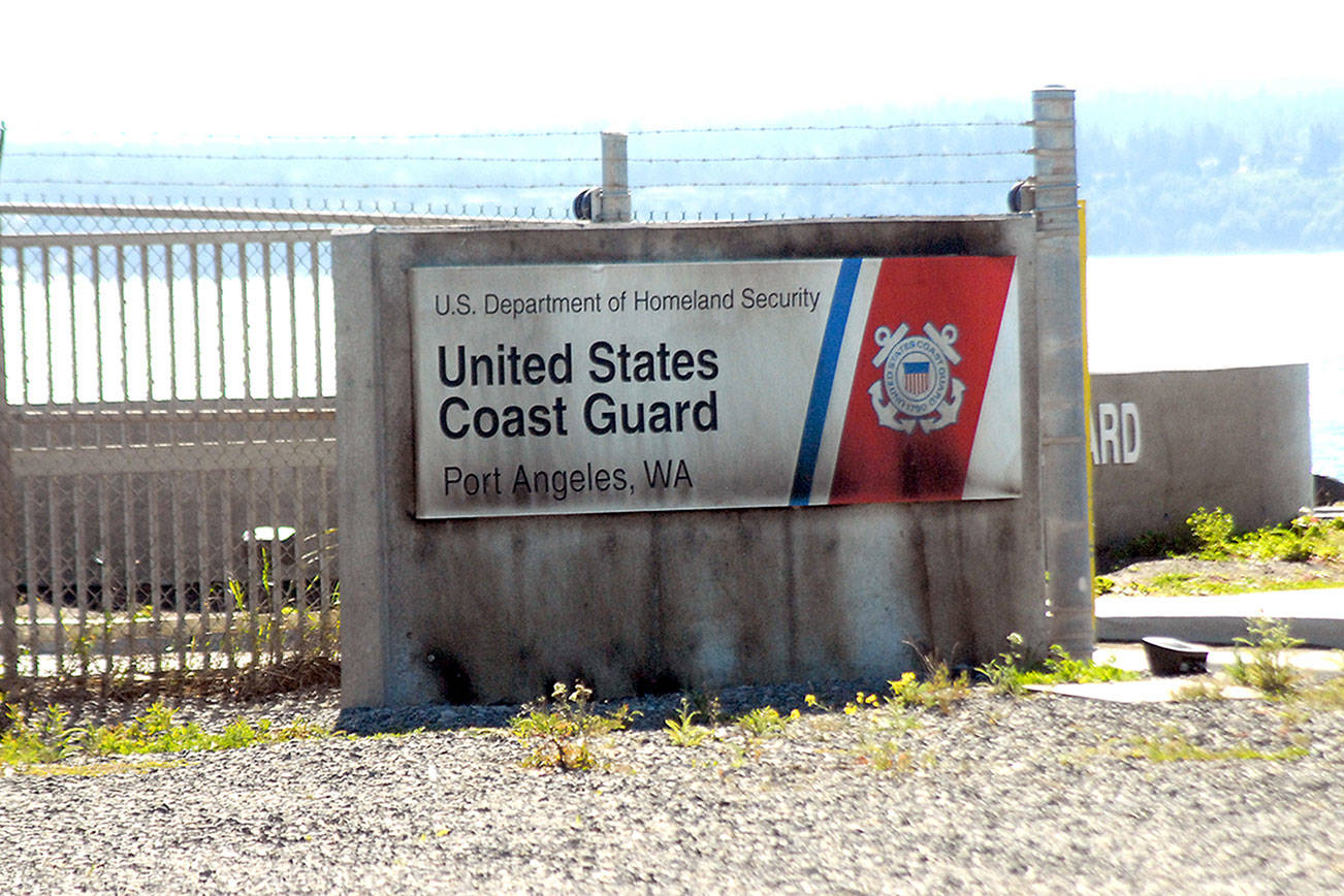 A sign at the entrance to Air Station/Sector Field Office Port Angeles on Ediz Hook is shown Wednesday after it had been set afire. (Keith Thorpe/Peninsula Daily News)