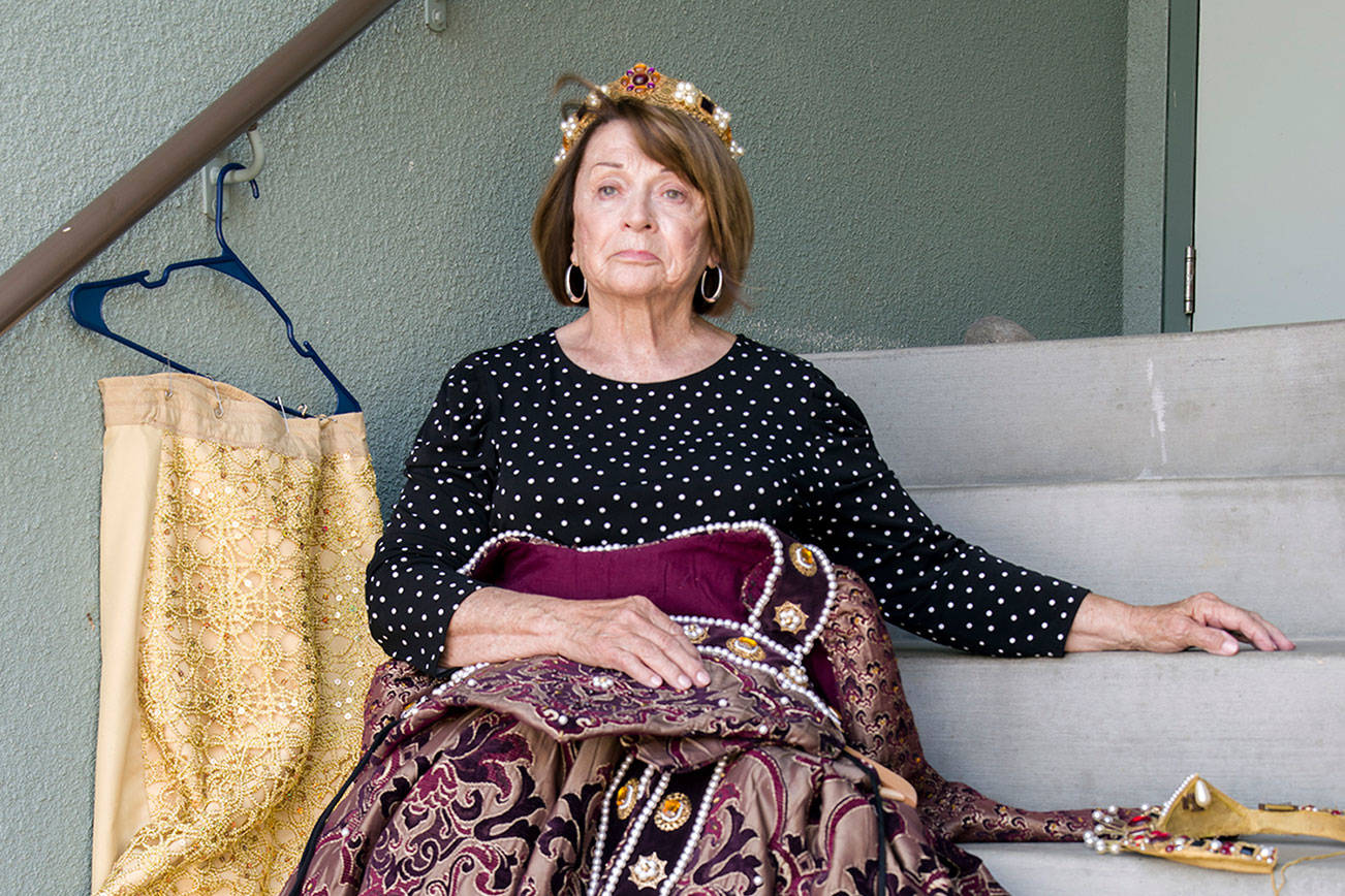 When you possess a queen’s dignity, any set of theater steps becomes a throne. Patty McArthur poses with her handmade Queen Elizabeth I costume on the steps of OTA, near where she will reign over the Renaissance Faire this coming weekend in Sequim. “When I put these on, I don’t think of myself.” Emily Matthiessen/Olympic Peninsula News Group