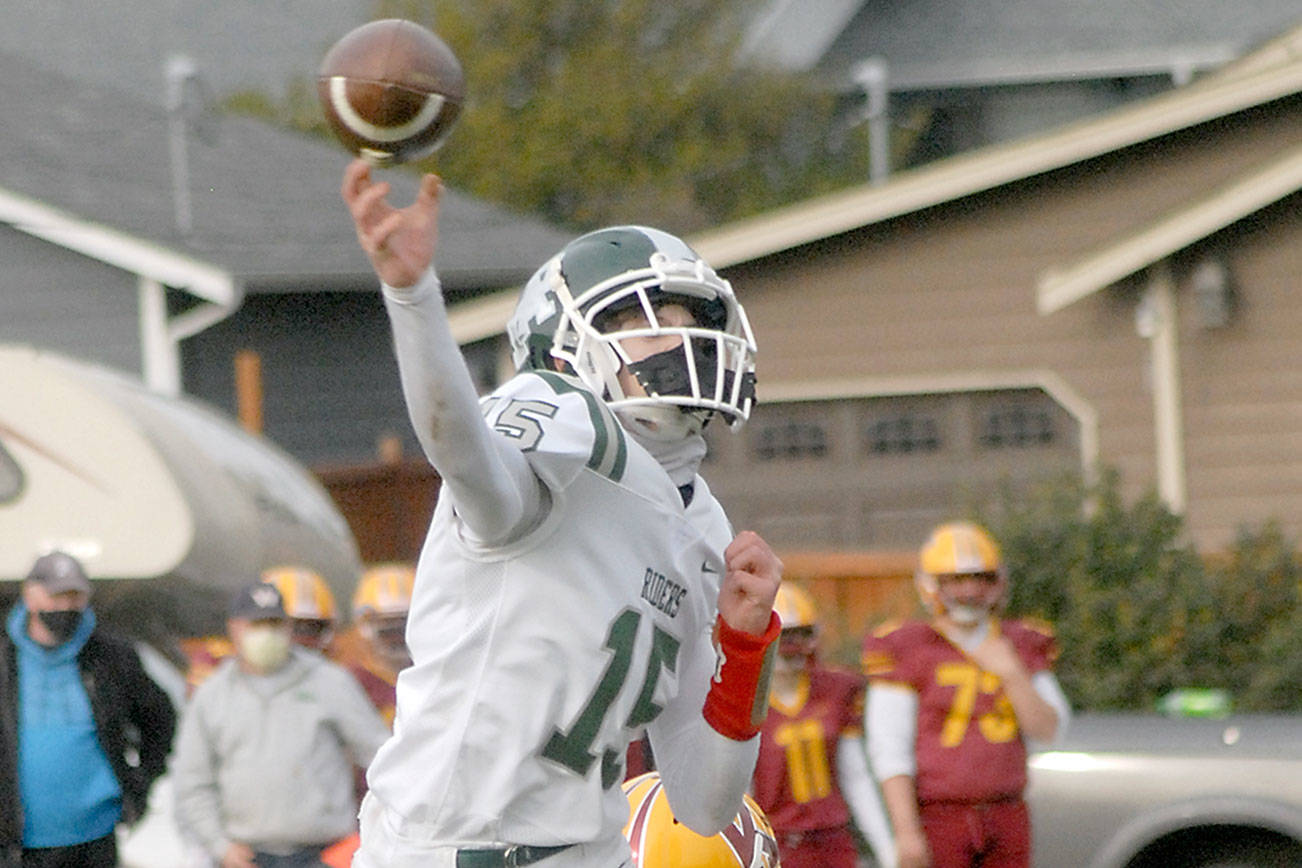 Keith Thorpe/Peninsula Daily News
Port Angeles quarterback Parker Nickerson gets off a pass as Kingston's Kyler Coe-yarr closes in during a Roughriders win earlier this year.