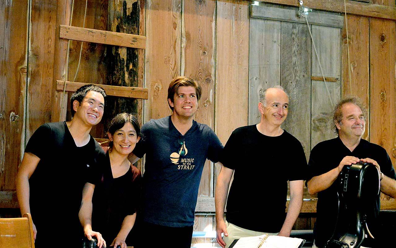 Following the Takács Quartet’s performance Sunday in the barn at Trillium Woods Farm, Music on the Strait co-artistic directors Richard O’Neill, far left, and James Garlick, center, take a breather. With them are quartet violinists Harumi Rhodes and Edward Dusinberre and cellist András Fejér. (Diane Urbani de la Paz/Peninsula Daily News)