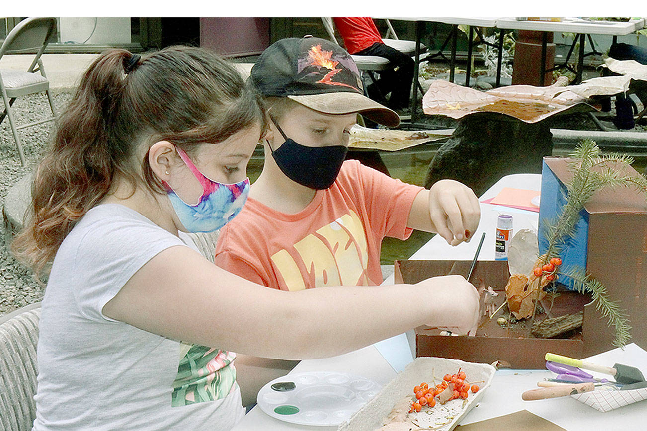 Jasmine Paul, 9, left, and John Hall, 10, put together a habitat diorama in which animals might live in nature after gathering materials in Webster's Woods at Port Angeles Fine Art Center. The diorama is just one of many projects and games students will participate in this week as part of art camps at the center, which is hosting two weeks of camps focusing on different ways in which science and art intersect. This week's half-day sessions are focused on Nature Art Camp and Treasure Map and Geocache. Next week's camps, The Art of Science Journals and Sculpture Design for Kids, are full, but students can be placed on a waiting list. Registration for a session is $100 for arts center members and $120 for non-members. For more information, visit www.pafac.org/summercamp.html or email rachel@pafac.org.