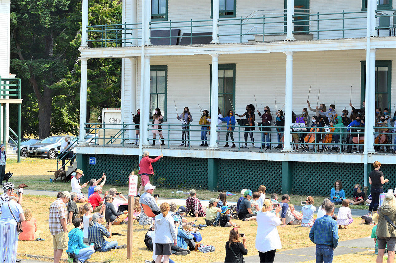 Performer and teacher Kristin Smith, standing on the grass, is among the faculty members hosting a free concert by the YEA Music students this Friday at Fort Worden State Park. (Diane Urbani de la Paz/Peninsula Daily News)