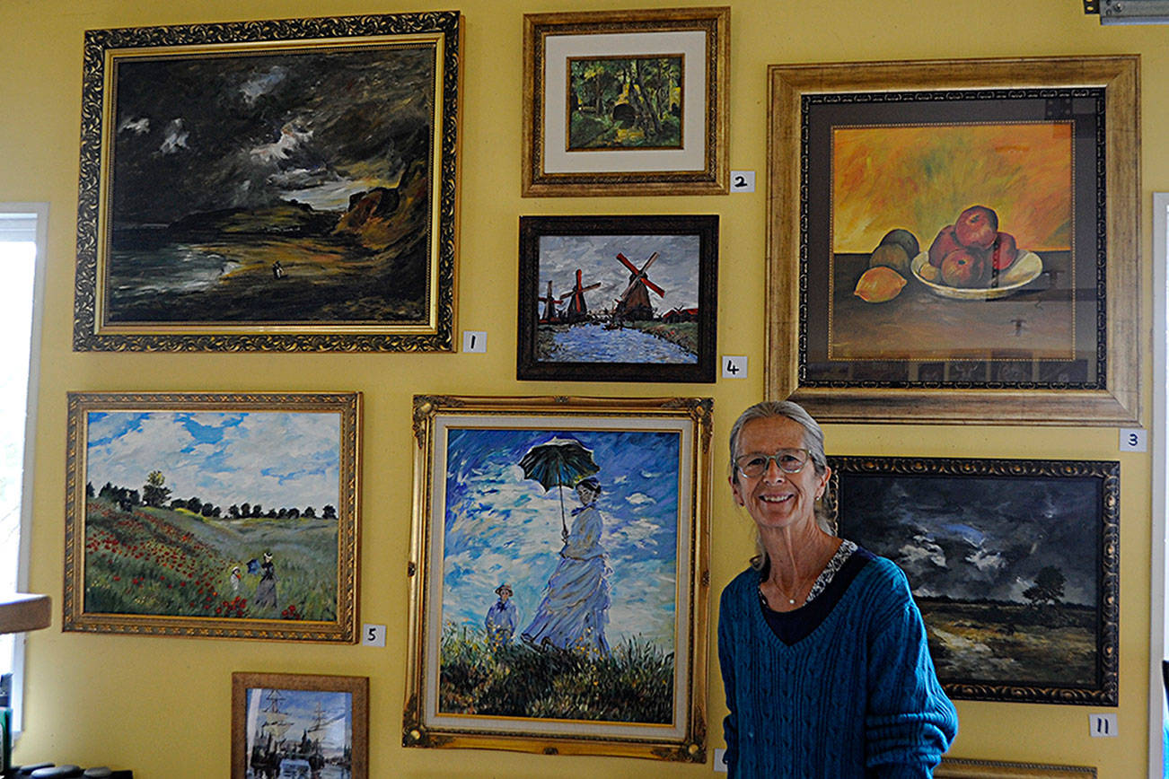 Carrie Rodlend plans to auction off more than 30 reimagined classic paintings, such as Claude Monet’s “Woman with a Parasol – Madame Monet and Her Son” on Saturday from her home studio in Dungeness. She’s worked more than a year beside her students on reimagining classic paintings to teach new techniques. Matthew Nash/Olympic Peninsula News Group