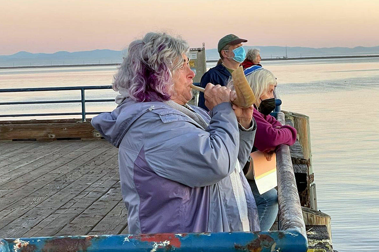 Jody Moss of Congregation Olympic B'nai Shalom blows the Shofar to usher in the Jewish New Year at sunrise Tuesday on City Pier in Port Angeles. (Paul Gottlieb/Peninsula Daily News)