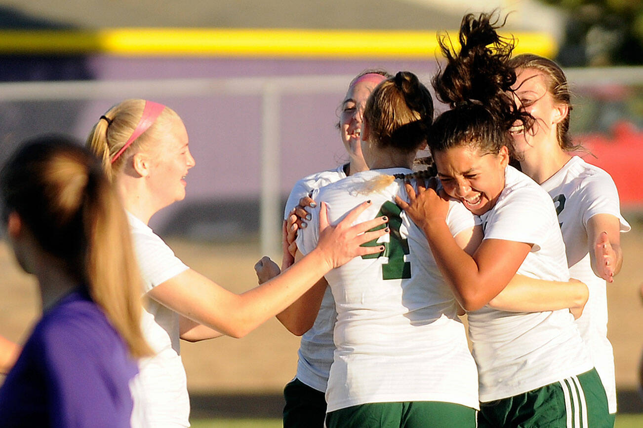 Michael Dashiell/Olympic Peninsula News Group
Teammates congratulate Port Angeles' Teagan Clark, No. 4, after the first of her two free-kick goals during the Roughriders 3-1 win over Sequim on Thursday.