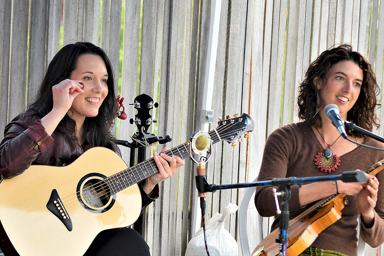 Micaela Kingslight, left, and Samara Jade are two-thirds of Three Wheels Turning, pictured during their May gig at the Keg & I in Chimacum. The trio, which also includes Aimée Ringle, will play from 6 p.m. to 8 p.m. this evening at Finnriver Farm & Cidery in Chimacum. (Diane Urbani de la Paz/Peninsula Daily News)