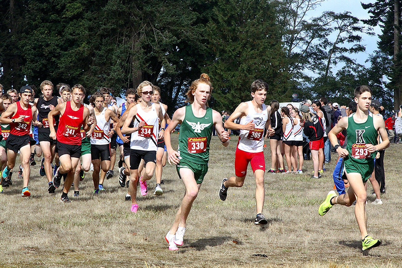 Port Angeles junior Jack Gladfelter, front left, races at the front of the pack at the opening of the varsity boys race at the 43rd Salt Creek Invitational at Salt Creek Recreation Area. Gladfelter finished second overall as the Roughrider boys claimed the varsity and junior varsity team titles. (Dave Logan/for Peninsula Daily News)