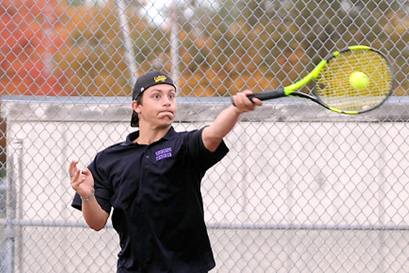 Sequim's Espn Judd rips a forehand volley as he and teammate Kaiden Jones take on Olympic's Warner Alexander and Freddy Enamorato on Wednesday in Sequim. Jones and Judd won, 6-2, 6-1, as the Wolves swept the Trojans 7-0. (Michael Dashiell/Olympic Peninsula News Group)