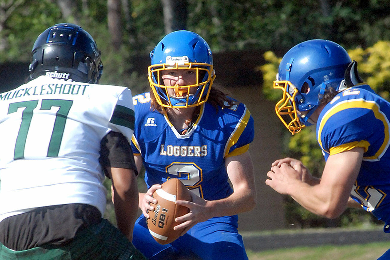 Keith Thorpe/Peninsula Daily News
Crescent quarterback Weston Hart, center, looks for help from teammate Wyatt Lee, right, as Muckleshoot Tribal defender Donavan Heredia closes in on Saturday in Joyce.