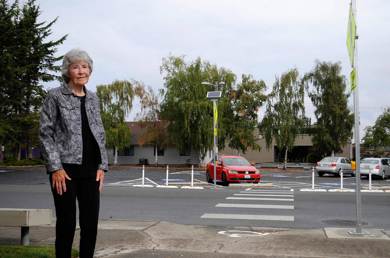 JoVonne Lingvall stands by a new pedestrian crosswalk at St. Joseph’s Catholic Church where she and her sister were struck by a vehicle last November. Lingvall survived, but her sister Lorraine (Reandeau) Anderson died four days later. (Matthew Nash/Olympic Peninsula News Group)