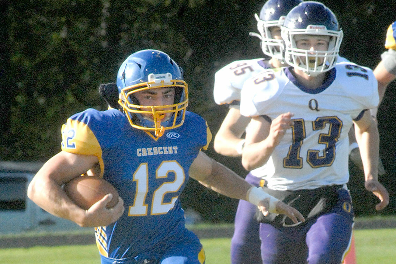 Keith Thorpe/Peninsula Daily News
Crescent's Wyatt Lee, left, tries to outrun Quilcene's Kevin Alejo, front, and  Max Budnek on Thursday in Joyce.