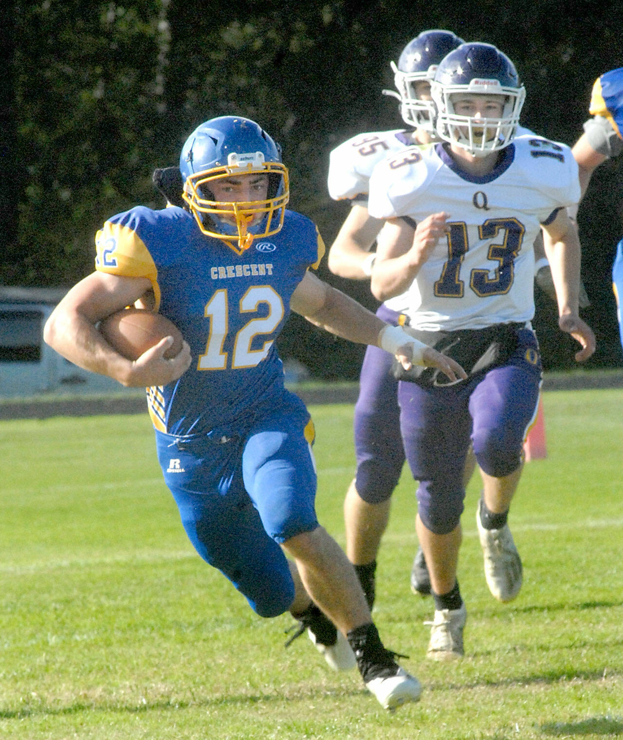 Keith Thorpe/Peninsula Daily News Crescent’s Wyatt Lee, left, tries to outrun Quilcene’s Kevin Alejo, front, and Max Budnek on Thursday in Joyce.