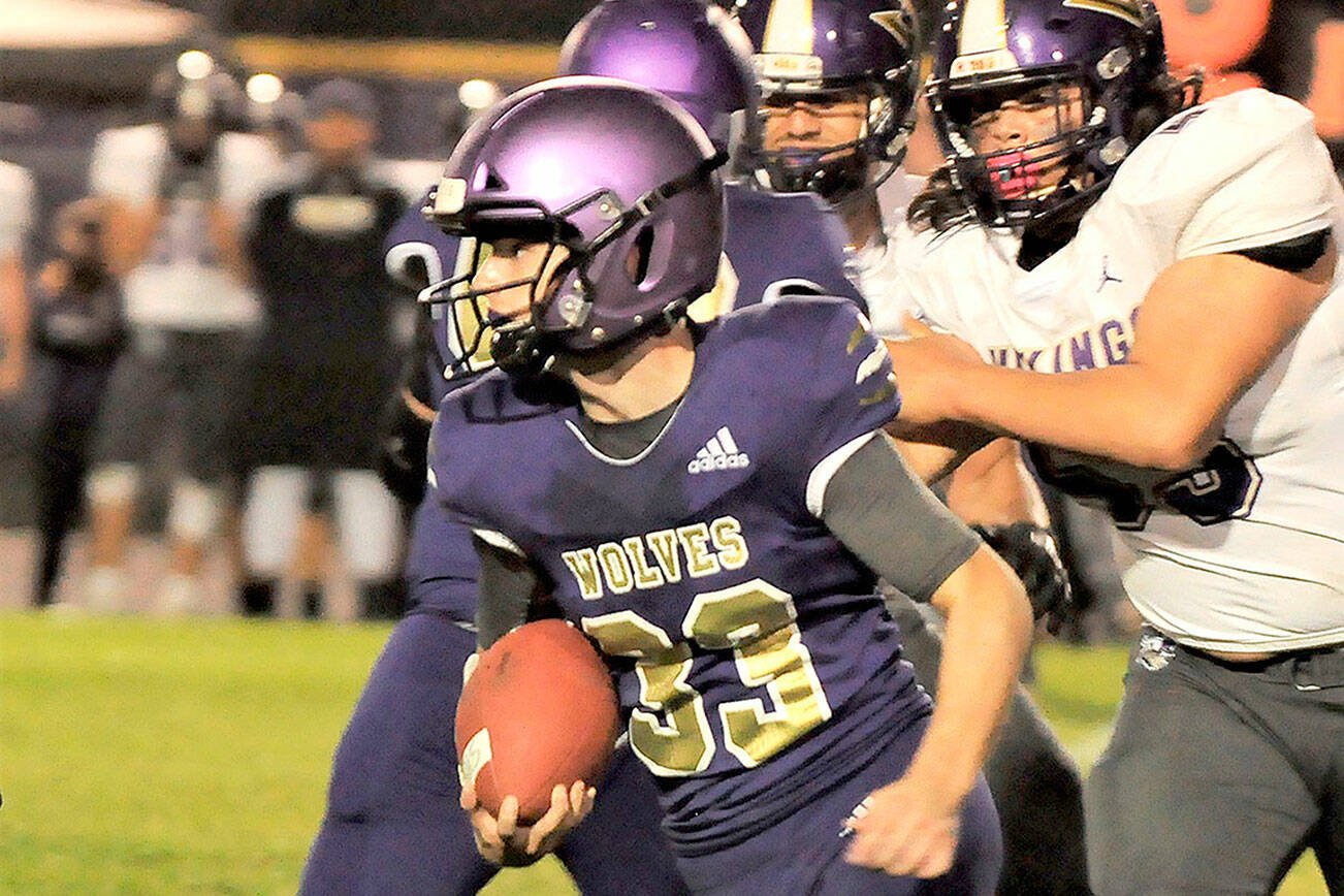 Sequim running back Sam Fitzgerald looks for running room in the Wolves' 49-7 loss to North Kitsap on Oct. 8. Fitzgerald led Sequim with 88 rushing yards. Sequim Gazette photo by Michael Dashiell