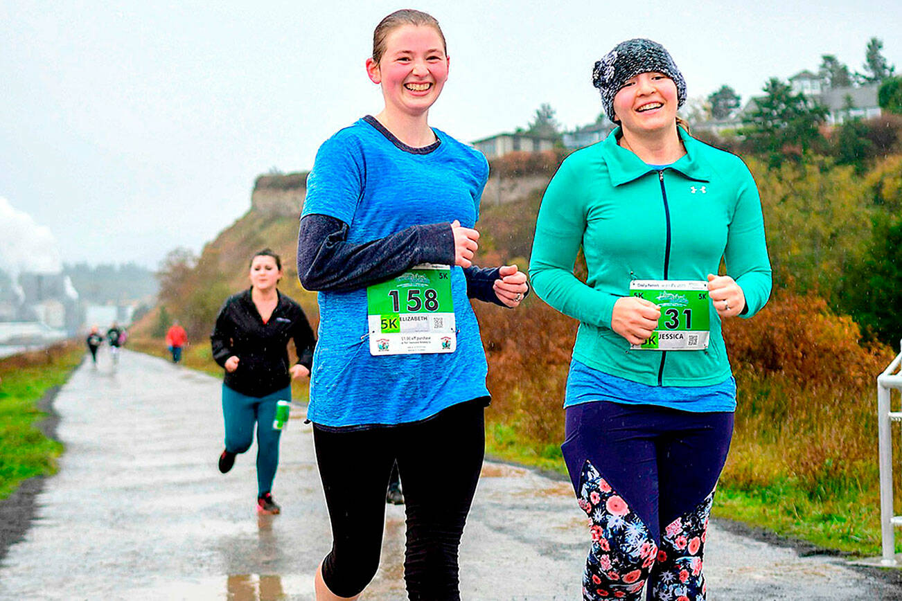 Elizabeth Hammel, left and Jessica Rohr, right cross the finish like at the Larry Scott Trail Run in 2019, the last year the event was run live.