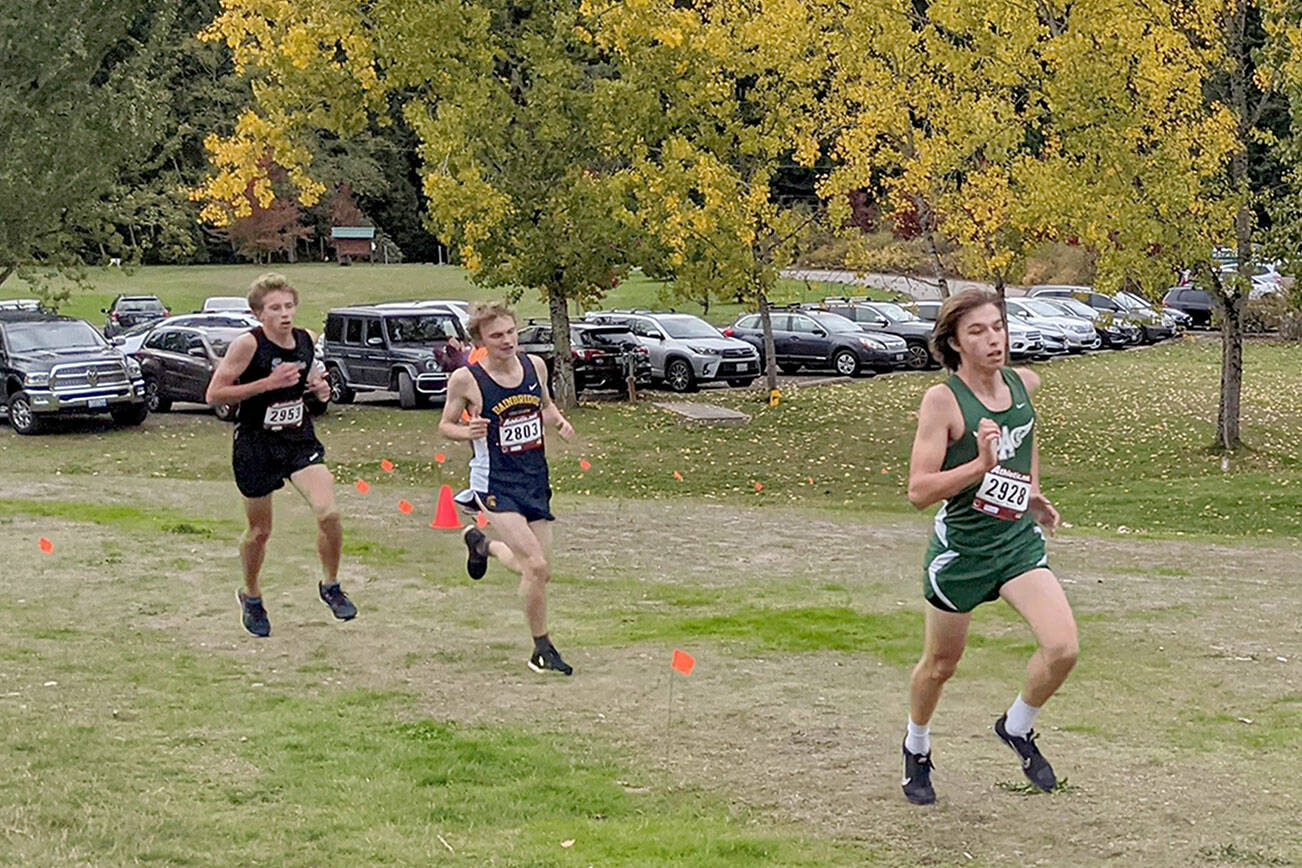 Rodger Johnson/Port Angeles Cross Country
Port Angeles' Max Baeder, right, leads on his way to winning the Olympic League cross country meet held Wednesday at Battle Point Park in Bainbridge. Sequim's Colby Ellefson, far left, finished second.