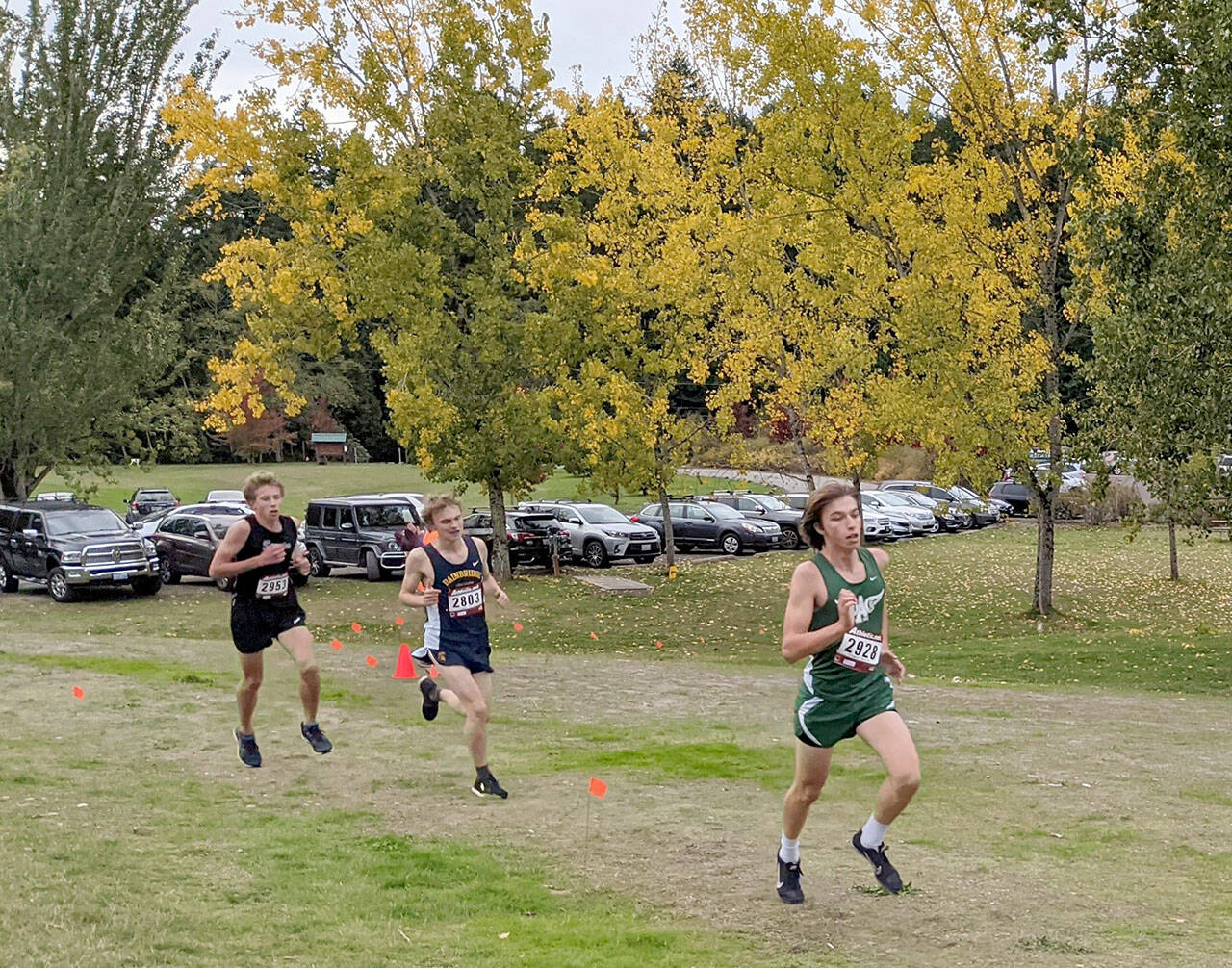 Port Angeles’ Max Baeder, right, leads on his way to winning the Olympic League cross country meet held Wednesday at Battle Point Park in Bainbridge. Sequim’s Colby Ellefson, far left, finished second. (Rodger Johnson/Port Angeles Cross Country)