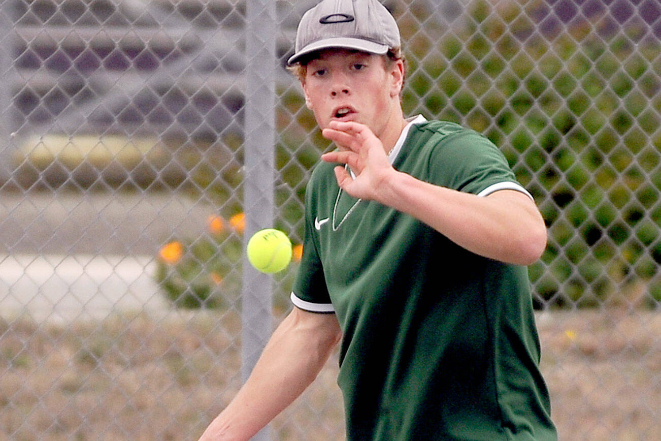 Michael Dashiell/Olympic Peninsula News Group
Port Angeles' Reef Gelder returns a volley during his No. 1 singles match with Sequim's Garrett Little on Thursday. Little and the Wolves won the match 4-3.