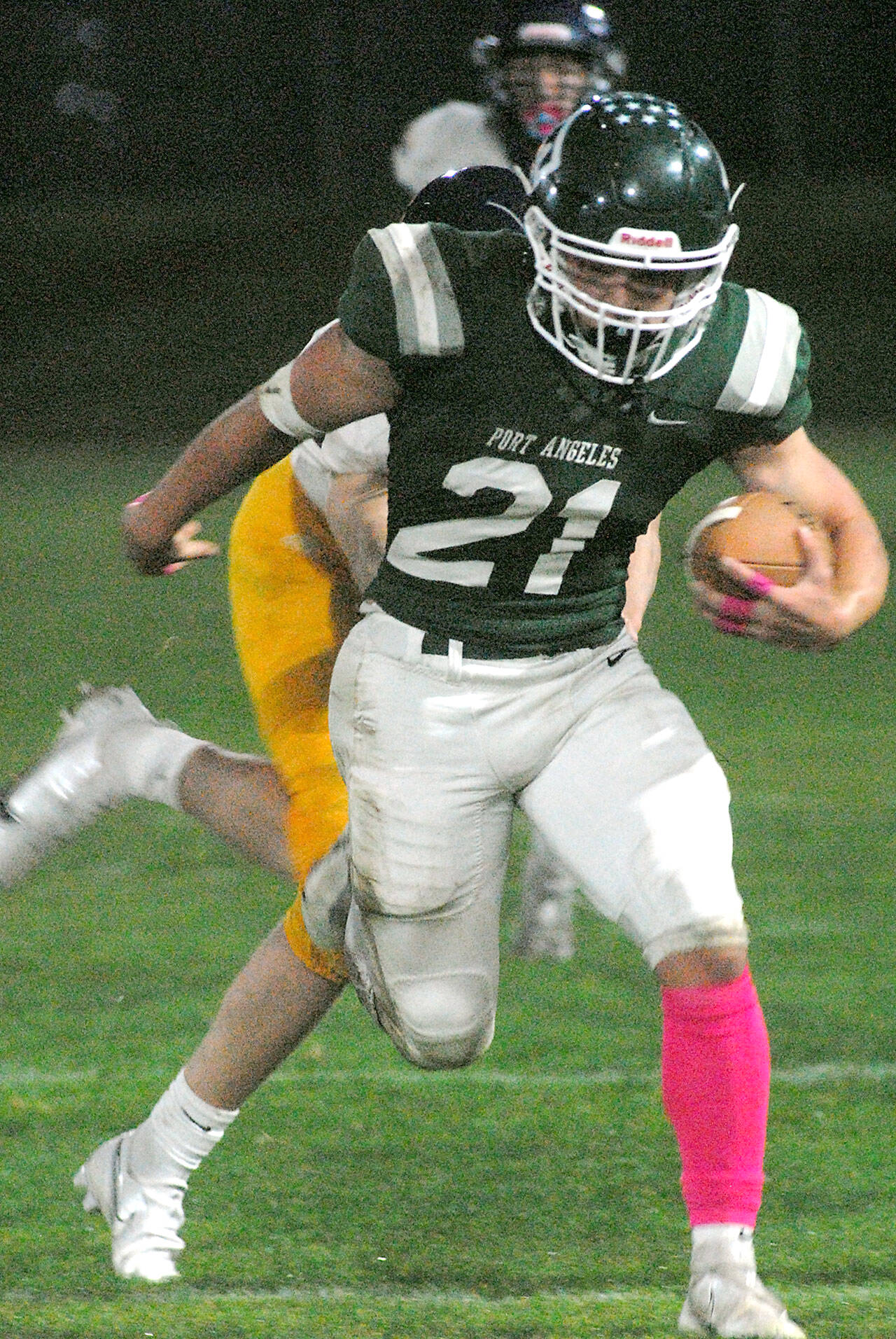 Keith Thorpe/Peninsula Daily News Port Angeles’ Daniel Cable escapes the Bainbridge defense on Friday night at Port Angeles Civic Field.