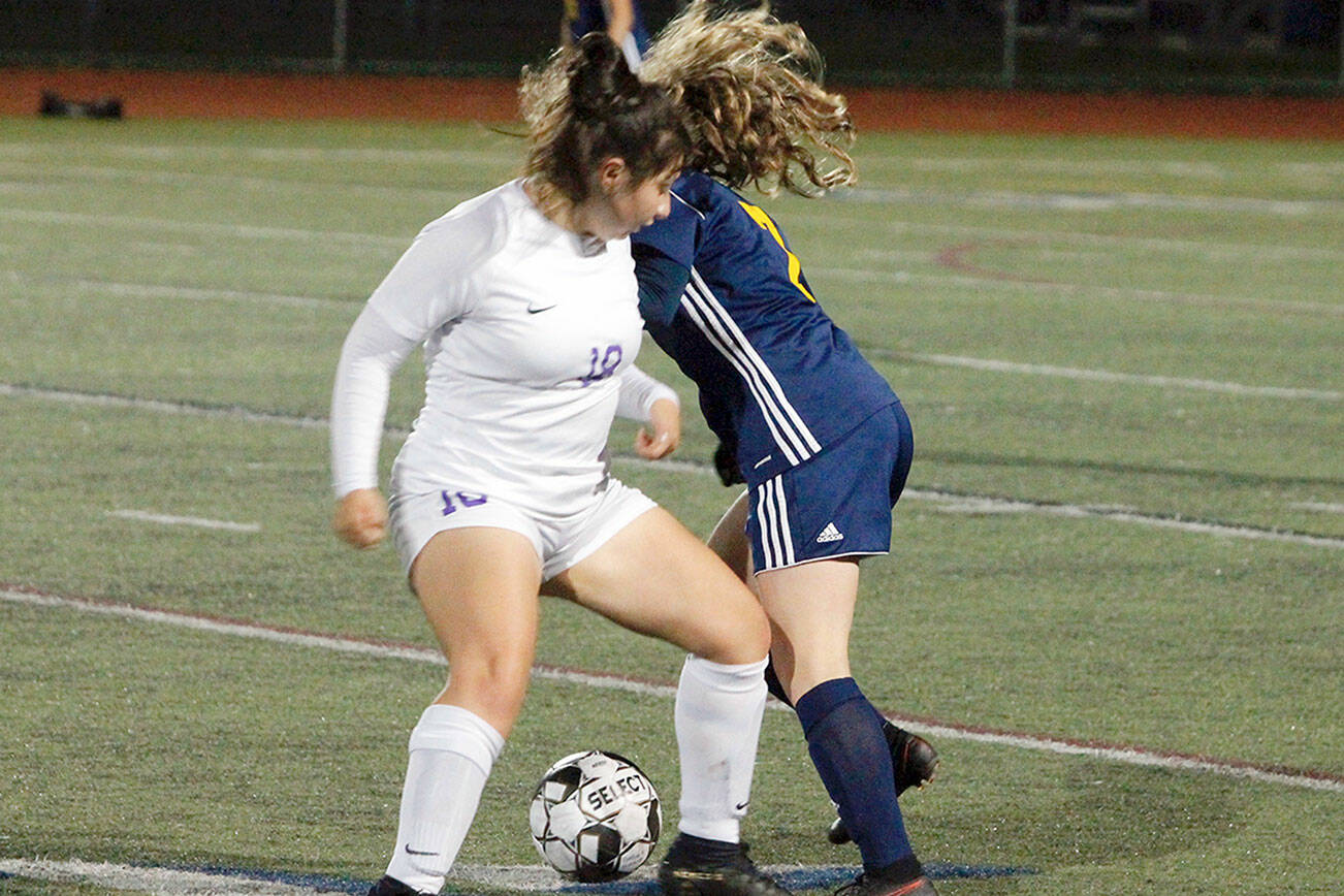 Mark Krulish/Kitsap News Group
Sequim's Samantha Gonzalez, left, gets tangled up with Bainbridge's Gabby Weis at midfield during a 1-0 loss to the Spartans on Thursday.