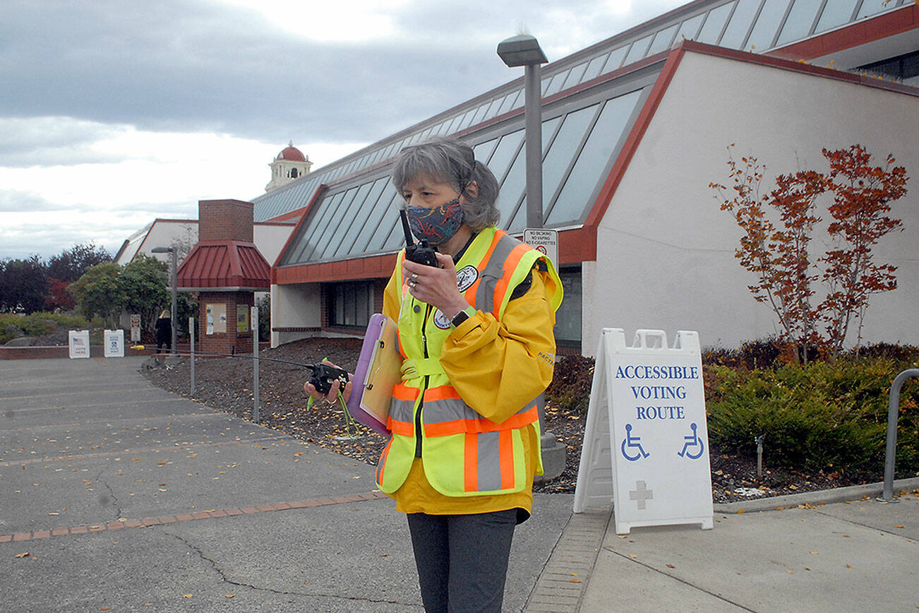 Ham radio operator Kathleen Reiter, training coordinator for Amateur Radio Emergency Services, relays radio messages outside the county courthouse during Thursday’s Great ShakeOut, an international drill to practice how to drop, cover and hold in the event of an earthquake. In Clallam County, numerous schools and other agencies practiced what to do in an emergency. Included in the drill was the sounding of tsunami sirens across the state. (Keith Thorpe/Peninsula Daily News)