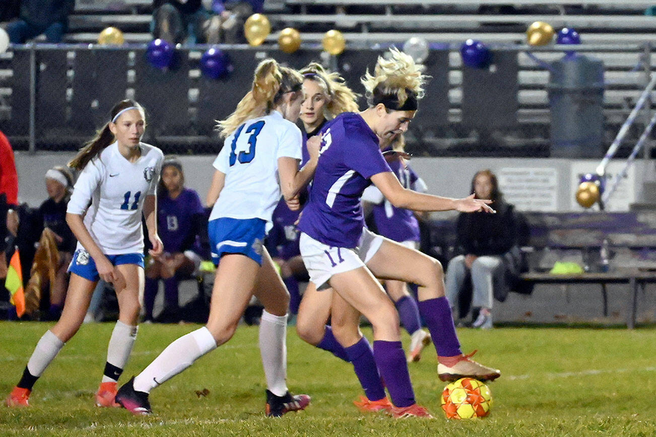 Michael Dashiell/Olympic Peninsula News Group
Sequim defender Kaia Lestage, right, puts a boot on the ball during the Wolves 6-0 win over North Mason on Wednesday.