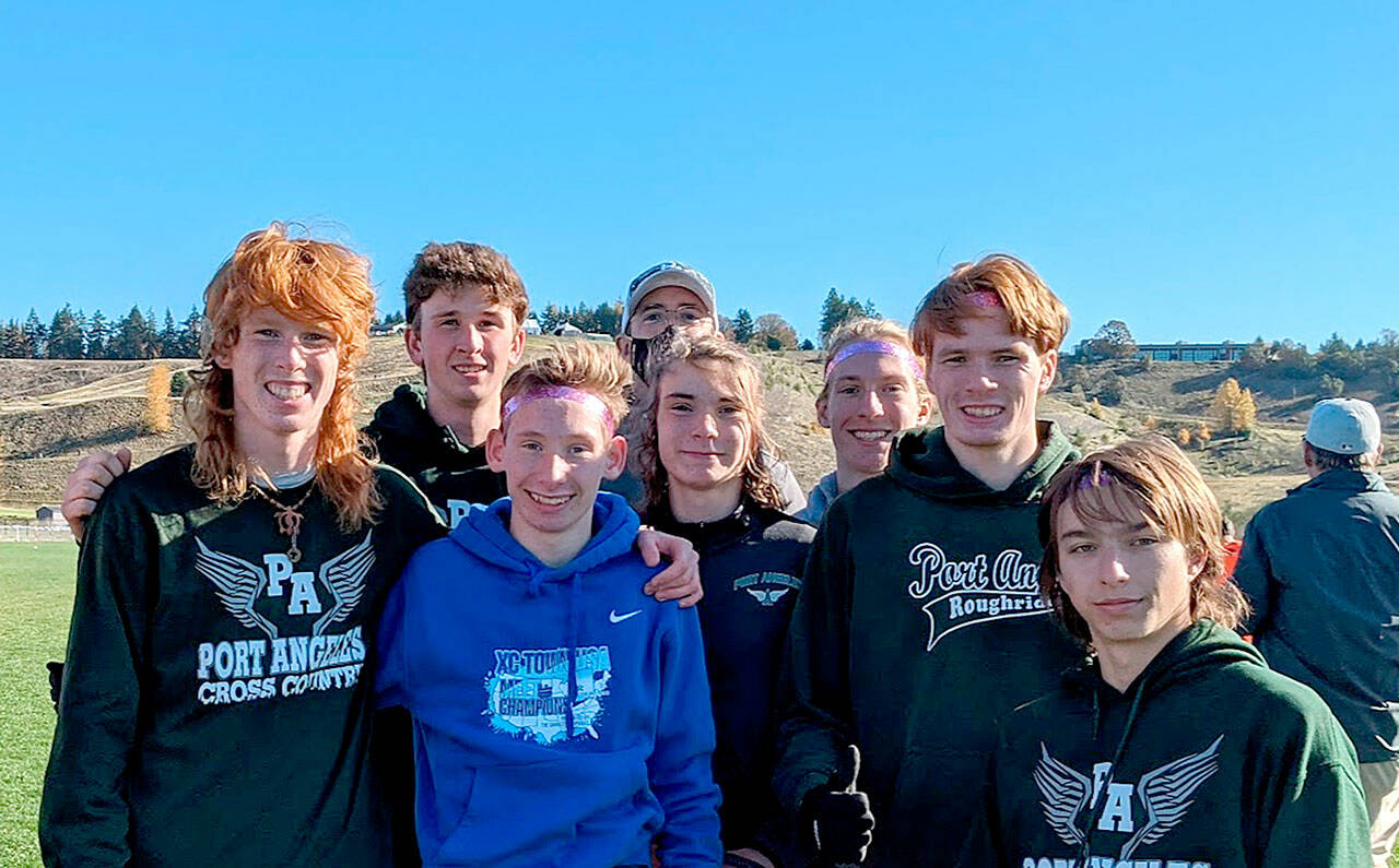 The Port Angeles cross country team, from left Jack Gladfelter, Naaman McGuffey, Langdon Larson, Coach Rodger Johnson, Kowen Kasten, Josh Gavin, Jason Gladfelter and Max Baeder, took first place at district.