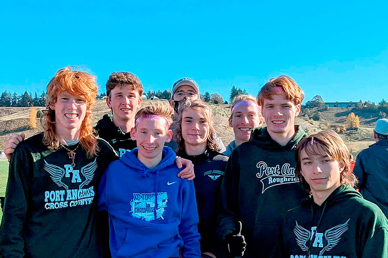 Port Angeles cross-country runners, from left Jack Gladfelter, Naaman McGuffey, Langdon Larson, Coach Rodger Johnson, Kowen Kasten, Josh Gavin, Jason Gladfelter and Max Baeder won the District 3 championship this weekend and qualified for the state 2A meet. (Courtesy photo)