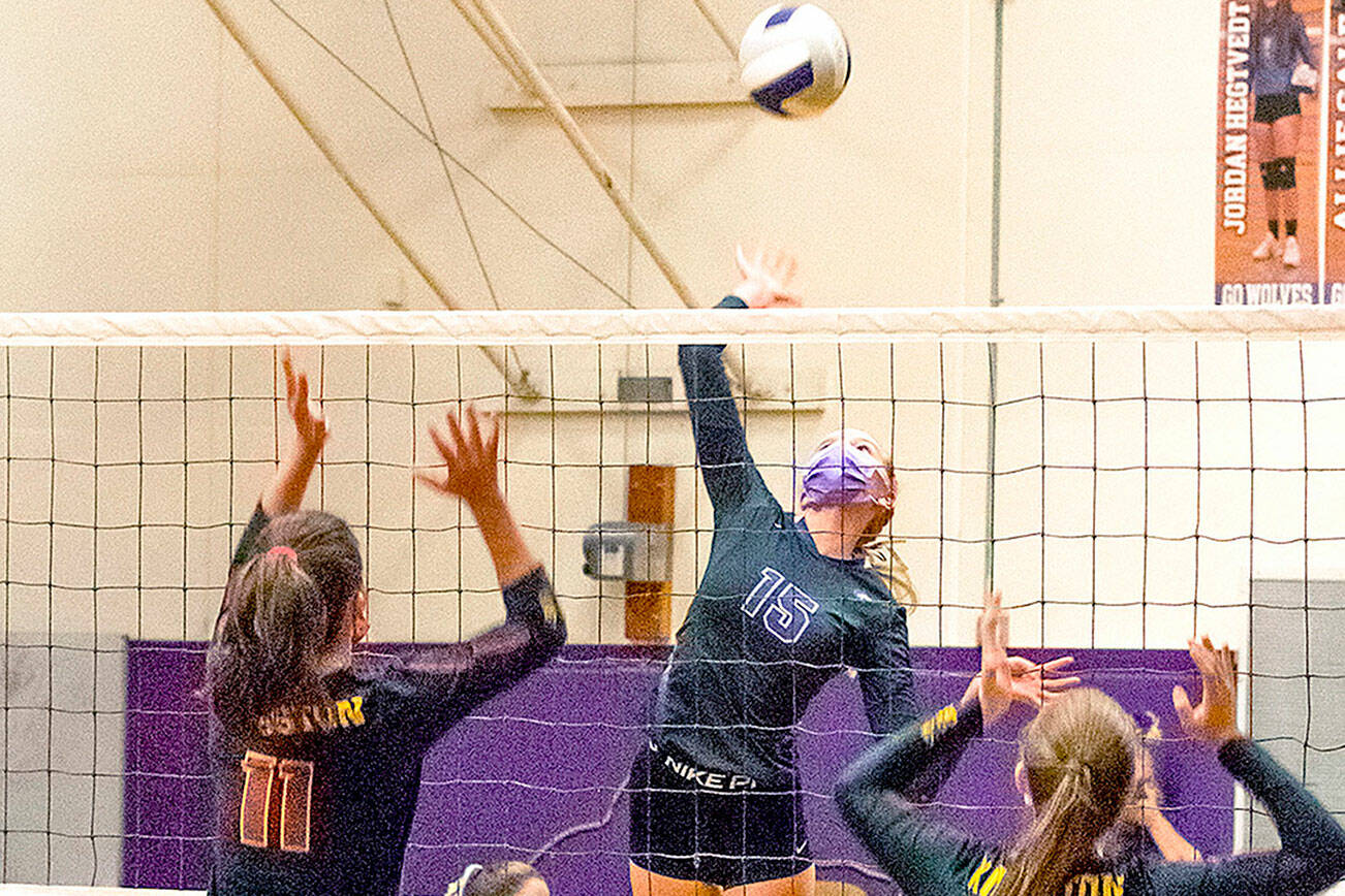 Emily Matthiessen/Olympic Peninsula News Group
Sequim's Kendall Hastings (15) looks to put a spike past the block attempts of Kingston's Marion Stejer (11) and Eva Stejer (2) in the Wolves' 3-1 win over Kingston on Tuesday.