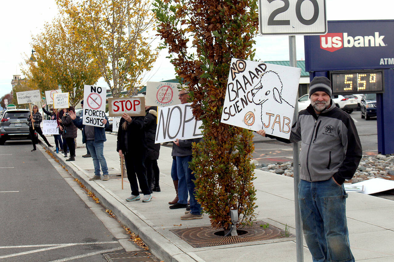 About 50 people lined the sides of Water Street in Port Townsend near the ferry terminal Wednesday morning. (Zach Jablonski/Peninsula Daily News)