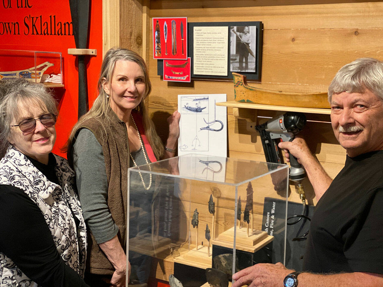 Sequim Museum Director Judy Stipe, left, and volunteers Bob Stipe, exhibit woodworker, and Katherine Vollenweider, volunteer designer and curator, put the finishing touches on the new exhibit, “Journey Through Time,” opening this week at the Sequim Museum & Arts, 544 N. Sequim Ave. Submitted photo