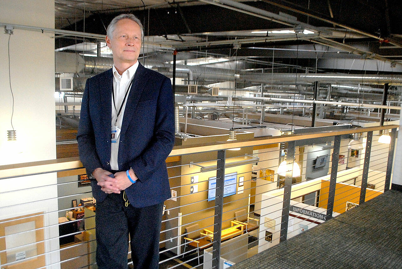 Michael Maxwell, chief executive officer of the North Olympic Healthcare Network, stands on a balcony overlooking the organization's main clinic in downtown Port Angeles on Wednesday. (Keith Thorpe/Peninsula Daily News)