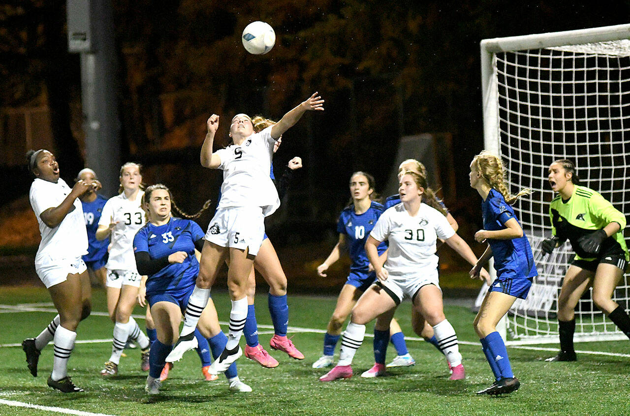 Peninsula College women battle for a ball in the box in front of the Clark goal in Sunday’s NWAC soccer championship game. From left are Peninsula players Tommylia Dunbar, Cerese McMillian (33), Kascia Muscutt (5) and Addy Becker (30). (Jay Cline/Peninsula College)