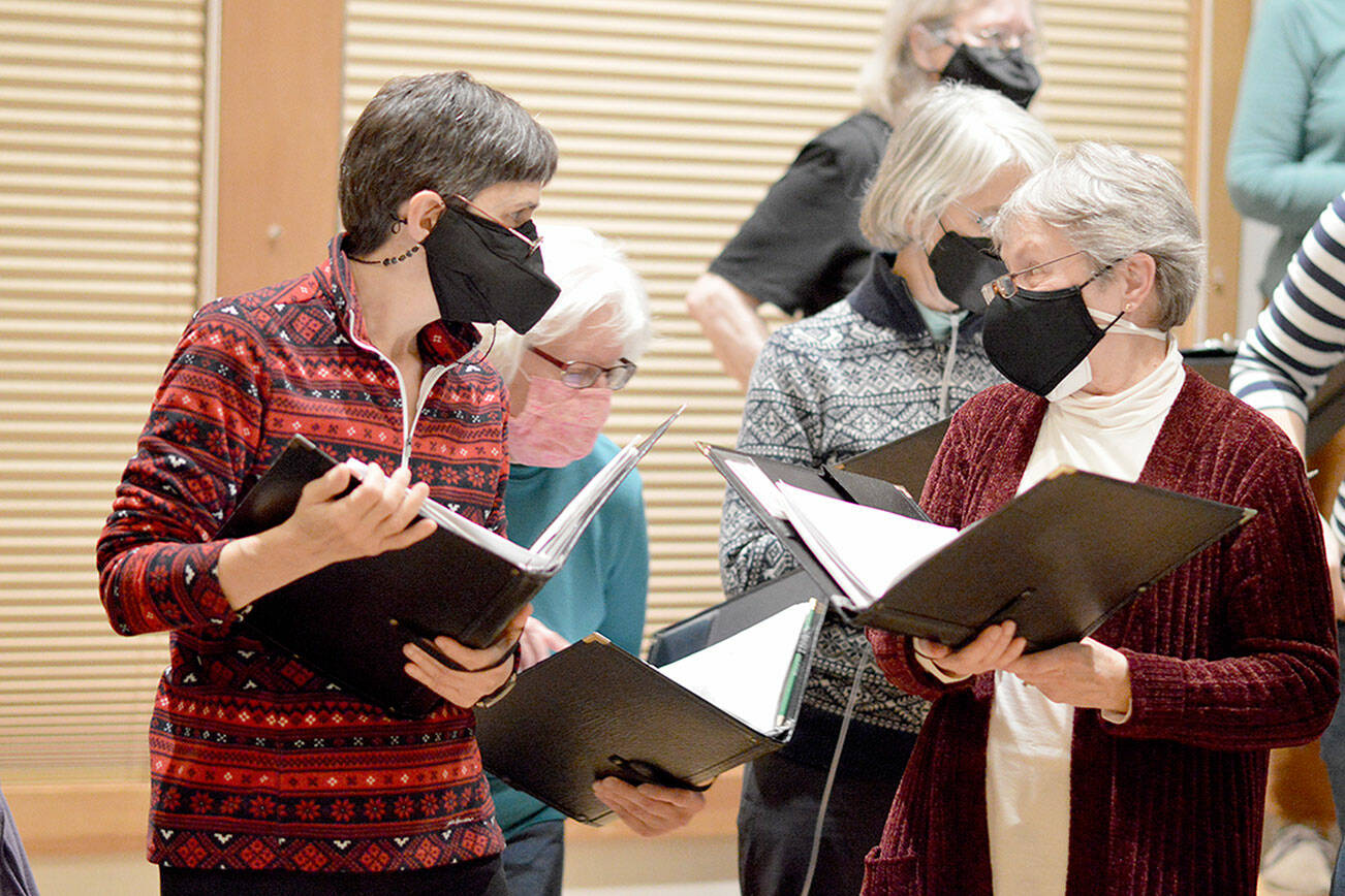 In rehearsal earlier this week, Rainshadow Chorale sopranos -- from left, Elizabeth Bindschadler, Marci Melvin, Katy Ottaway and Patricia Hauschildt -- take a quick breather. The chorale will give its first concerts in two years tonight and Saturday. Diane Urbani de la Paz/Peninsula Daily News