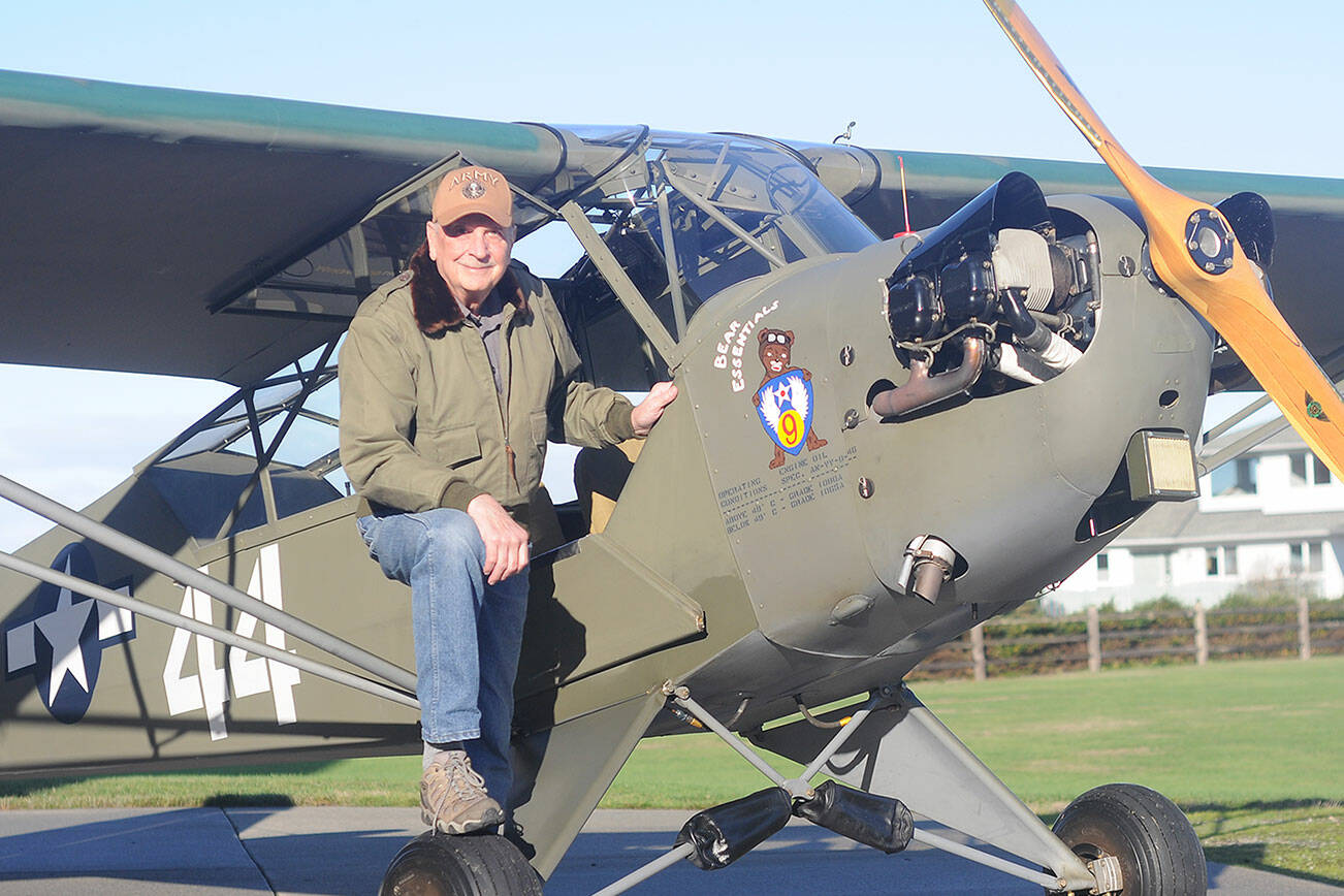 Sequim pilot and veteran David Woodcock stands near his 1944 Piper Cub L-4H, an aircraft that saw action at the Battle of the Bulge. (Michael Dashiell/Olympic Peninsula News Group)