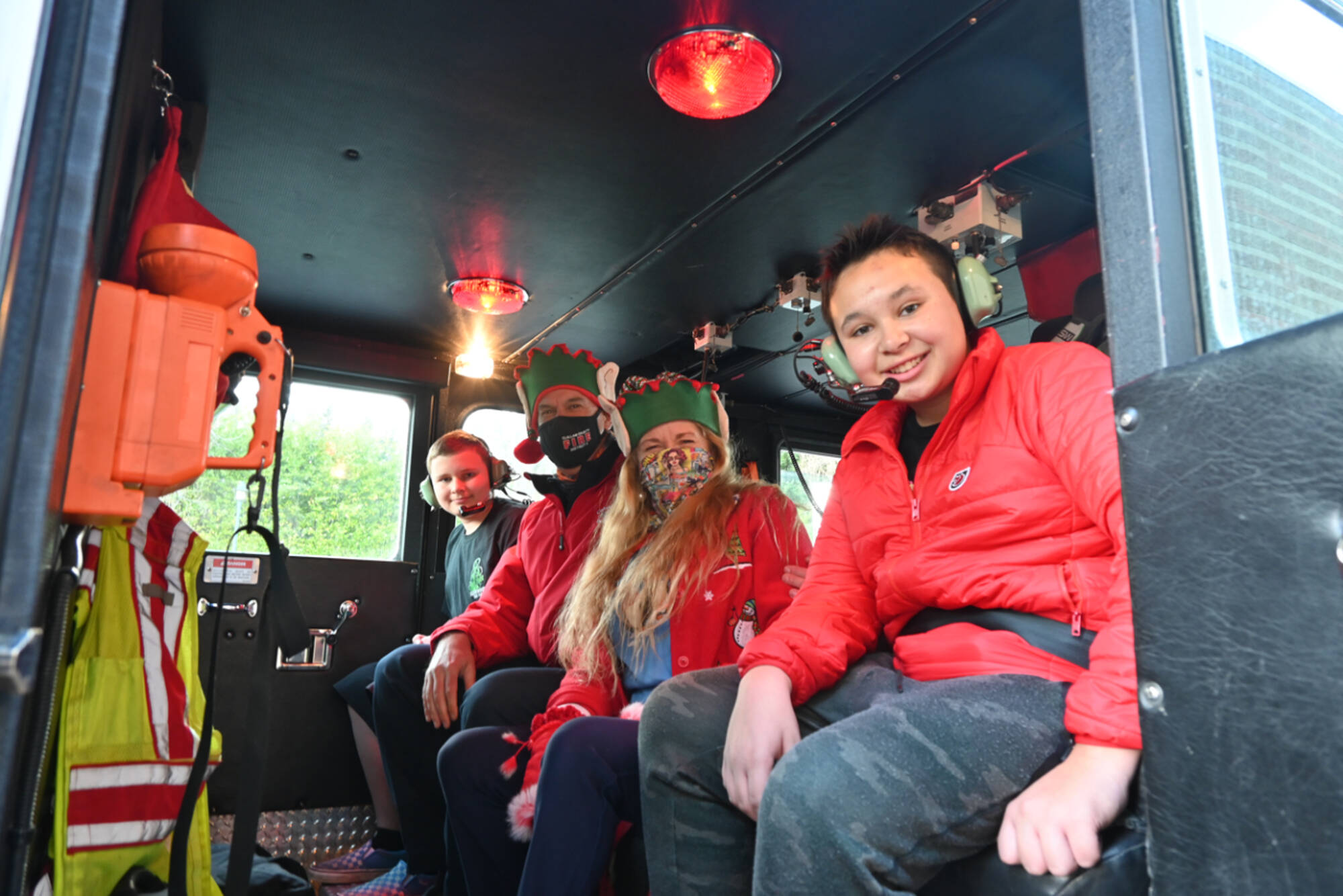 Sequim seventh-graders Michael Lusk, far left, and Kingston Stevens, pictured here with Scott and Laura Lee Johnson, enjoy a ride home in a firetruck in mid-December, thanks to Peninsula Behavioral Health's “Adventure Auction” on Nov. 6. The auction saw "adventures," rather than items, auctioned off to raise funds for the entity. Auction items included a helicopter flight, guided hikes and fishing trips. In Port Angeles, a preschool student got a ride to class in a fire truck. Michael Dashiell/Olympic Peninsula News Group