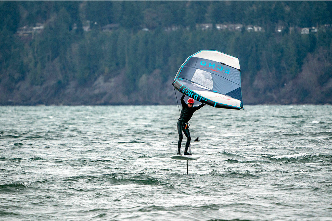 A wing-foiler hones his skills on windy Port Townsend Bay. The forecast calls for more seasonal temperatures this week with highs in the mid- to upper 40s and lows in the high 30s. (Steve Mullensky/for Peninsula Daily News)