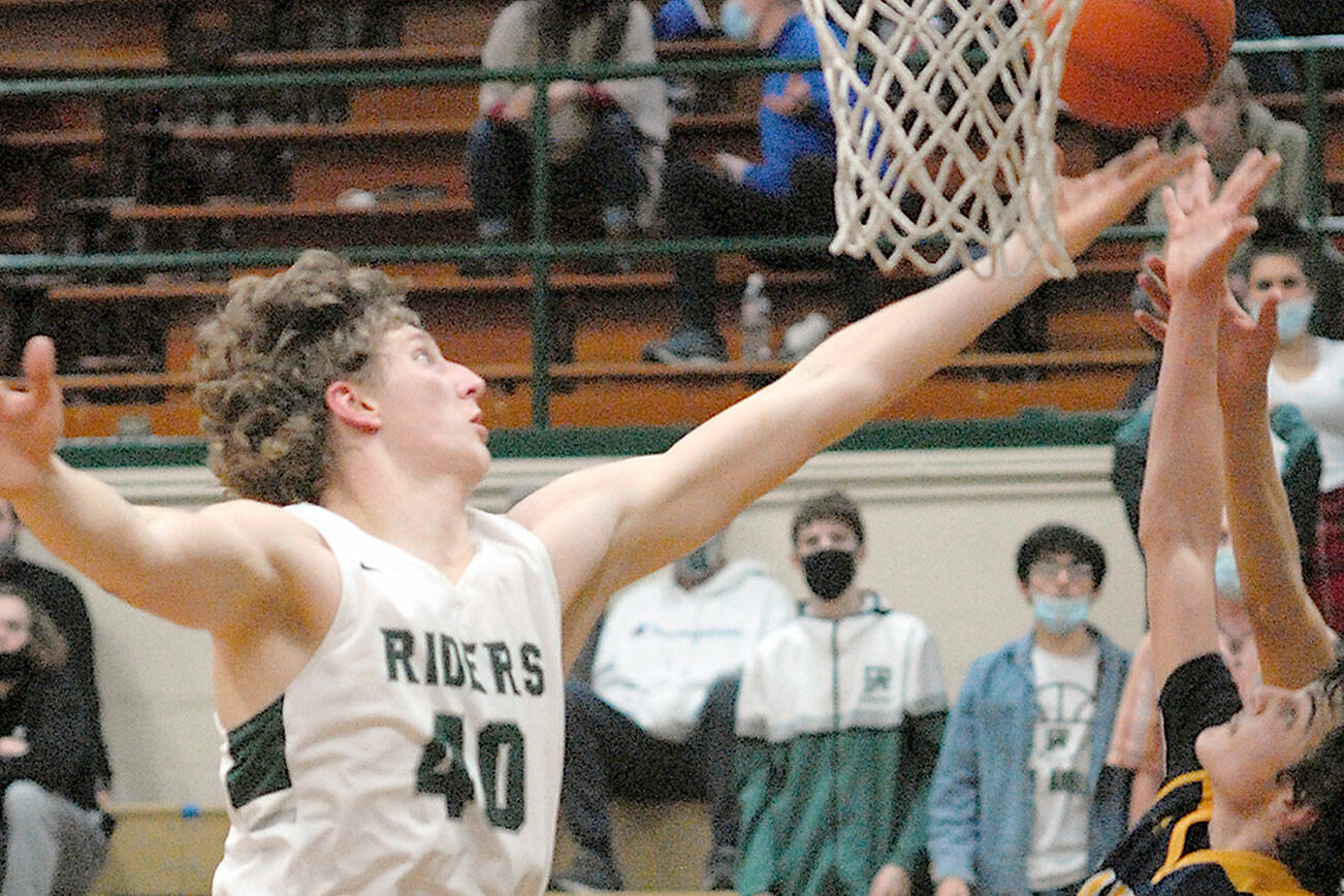 Keith Thorpe/Peninsula Daily News
Port Angele's John Vaara, left, tips the ball away from Bainbridge Island's Everett Moore, front, and Charlie Diiorio Triesch on Tuesday night at Port Angeles High School.