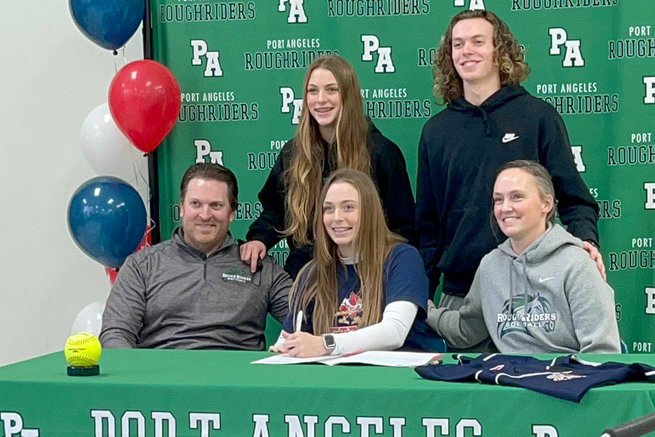 Port Angeles senior Teagan Clark, seated at center, signs a letter of intent to play softball at Skagit Valley College with her family in attendance including dad Dustin Clark, mom Tasha Clark, sister Teanna and brother Dru.