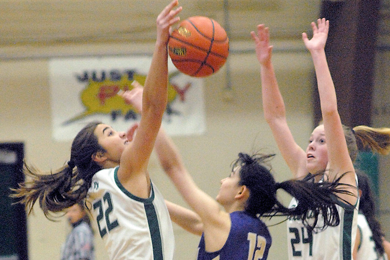 Keith Thorpe/Peninsula Daily News
Port Angeles' Eve Burke, left, and Anna Petty, right, surround North Kitsap's Jade Sunnenberg on Thursday night at Port Angeles High School.